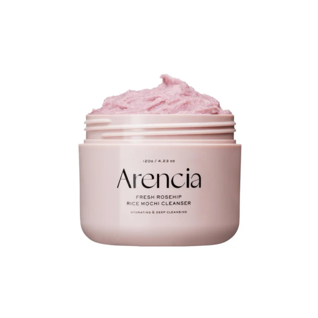 ARENCIA Fresh Rosehip Rice Mochi Cleanser is a soft, grainy cleanser that gently exfoliates while nourishing the skin. Formulated with Rice Powder and Sweet Almond Seed Meal, it helps remove dead skin cells and impurities for a smoother texture. Infused with Rosehip Extract, Apple Fiber, and Aloe Vera, it brightens, soothes, and hydrates, leaving skin refreshed and radiant. With its mochi-like texture, this cleanser provides a mild yet effective cleanse. Suitable for all skin types, especially dull and roug