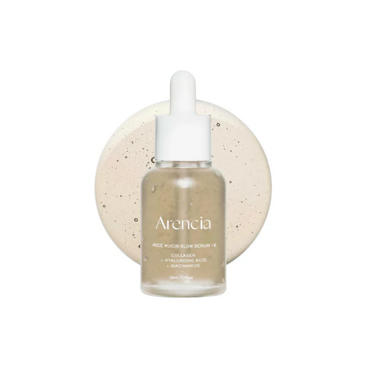 ARENCIA Rice Mucin Glow Serum is a brightening and firming serum that restores radiance and smoothness to the skin. Powered by Rice Ferment Filtrate, Niacinamide, and Tranexamic Acid, it helps even skin tone, fade dark spots, and boost luminosity. Enriched with Collagen, Hyaluronic Acid, and Beta-Glucan, it delivers deep hydration and plumping care, while Retinal, Panthenol, and Vitamin E support skin renewal and elasticity. Lightweight yet nutrient-rich, this serum leaves skin soft, glowing, and revitalize