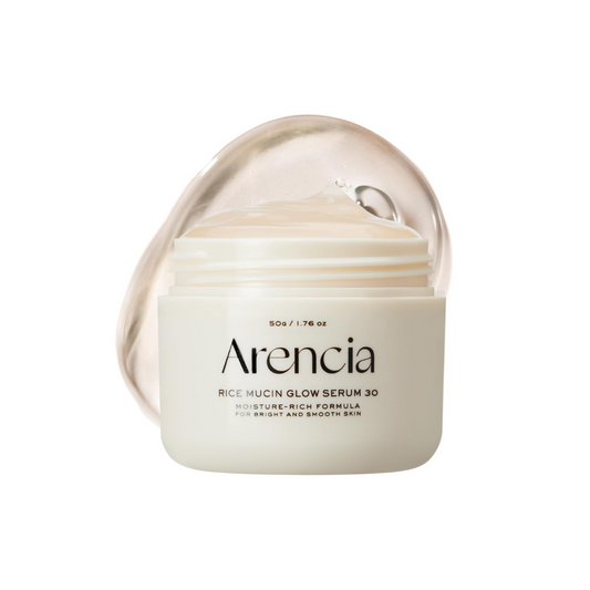 ARENCIA Rice Mucin Glow Serum 30 is a brightening and hydrating serum formulated with Rice Ferment Filtrate (Sake) to boost radiance and improve skin texture. Enriched with Niacinamide, Hyaluronic Acid, and Hydrolyzed Collagen, it deeply moisturizes, plumps, and smooths the skin. Retinal, Tranexamic Acid, and Vitamins help refine tone and support a healthy, glowing complexion. Its lightweight texture absorbs easily, leaving skin soft, luminous, and refreshed.