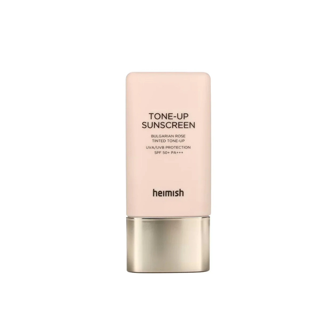 HEIMISH Bulgarian Rose Tinted Tone-Up Sunscreen SPF50+ PA+++ combines powerful sun protection with a natural tone-up effect, leaving your skin radiant and even-toned. Enriched with Rosa Canina Fruit Oil and Rosa Damascena Flower Water, this lightweight sunscreen deeply hydrates and soothes the skin. Infused with Tocopheryl Acetate, Hibiscus Sabdariffa Flower Extract, and Viola Tricolor Extract, it nourishes and protects while delivering a soft, luminous finish. The subtly tinted formula brightens the comple