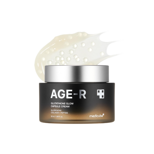 MEDICUBE AGE-R Glutathione Glow Capsule Cream is a radiance-boosting moisturizer designed to brighten and revitalize tired skin. Infused with Glutathione, Niacinamide, and Peptides, it helps improve skin tone, reduce dullness, and support elasticity. The unique capsule texture melts into the skin, delivering deep hydration with Ceramides, Collagen, and Betaine for a smooth, glowing finish. Ideal for anyone looking to achieve a fresh, luminous complexion.
