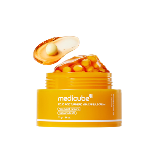 MEDICUBE Kojic Acid Turmeric Vita Capsule Cream is a brightening moisturizer designed to improve uneven skin tone and boost radiance. Formulated with Kojic Acid, Niacinamide, and Turmeric Extract, it helps reduce the appearance of dark spots while soothing and hydrating the skin. Enriched with Ceramide NP and Hyaluronic Acid, it supports the skin barrier and keeps skin smooth, soft, and refreshed.