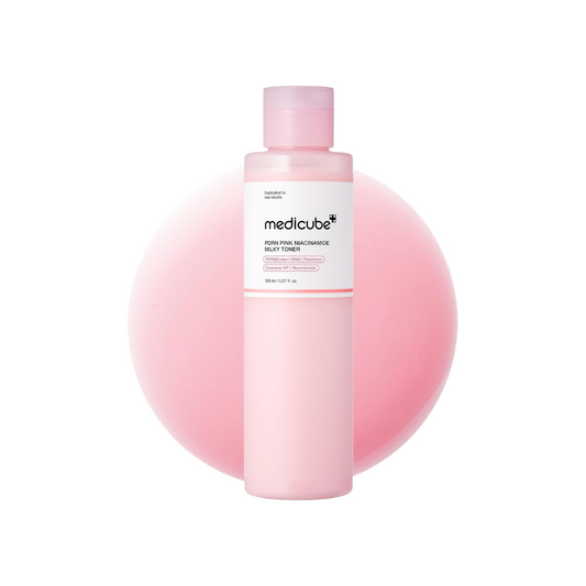 MEDICUBE PDRN Pink Niacinamide Milky Toner is a brightening and hydrating toner that helps refine skin tone and boost radiance. Infused with Niacinamide (50,000ppm) and PDRN (Sodium DNA), it targets dark spots, supports skin repair, and promotes a healthy glow. Enriched with Rice Bran, Jasmine Water, and Centella Asiatica Extracts, it soothes and nourishes, while Ceramides, Milk Protein, and Hyaluronic Acid strengthen the skin barrier and lock in moisture. Its soft, milky texture leaves the skin smooth, sup