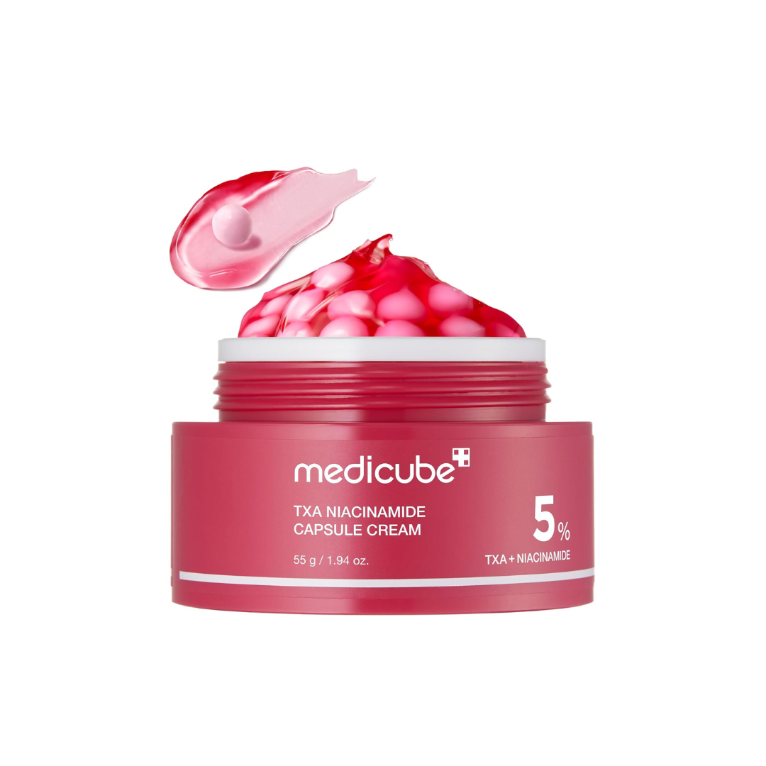 MEDICUBE TXA Niacinamide Capsule Cream is a brightening and hydrating moisturizer designed to improve uneven skin tone and dullness while supporting the skin barrier. Formulated with a high concentration of Niacinamide and Tranexamic Acid, it helps reduce the appearance of dark spots and discoloration for a clearer, more radiant complexion. Ceramide NP and multiple forms of Hyaluronic Acid provide deep hydration and help maintain moisture balance, while Panthenol and soothing botanical extracts calm and com