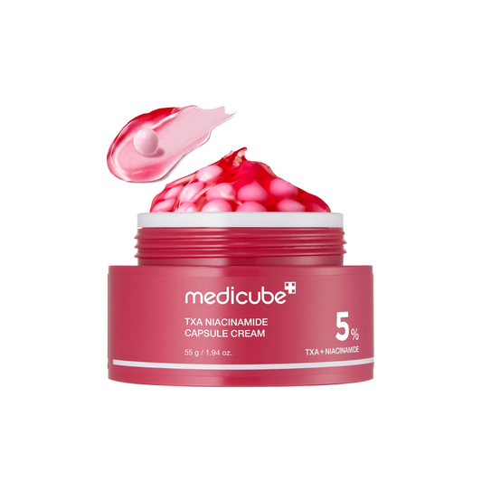 MEDICUBE TXA Niacinamide Capsule Cream is a brightening and hydrating moisturizer designed to improve uneven skin tone and dullness while supporting the skin barrier. Formulated with a high concentration of Niacinamide and Tranexamic Acid, it helps reduce the appearance of dark spots and discoloration for a clearer, more radiant complexion. Ceramide NP and multiple forms of Hyaluronic Acid provide deep hydration and help maintain moisture balance, while Panthenol and soothing botanical extracts calm and com