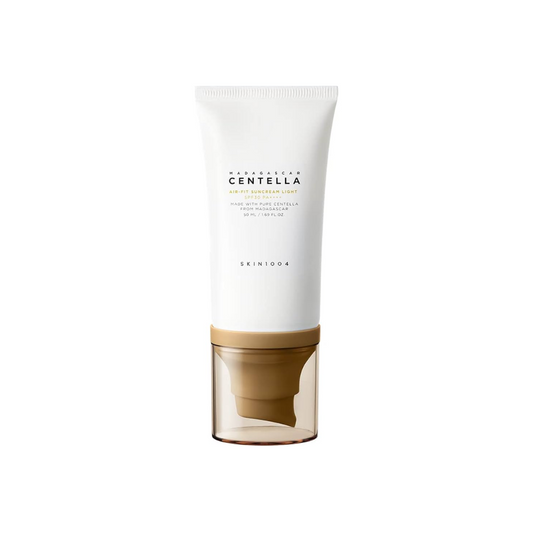 SKIN1004 Madagascar Centella Air-Fit Suncream Light offers SPF protection with a lightweight, non-greasy finish. Enriched with Centella Asiatica Extract (29,400 ppm), it soothes and calms irritated skin while Niacinamide brightens and improves tone. Infused with Houttuynia Cordata and Portulaca Oleracea Extracts, it hydrates and strengthens the skin barrier. Perfect for daily use, this gentle formula leaves your skin smooth, refreshed, and protected.