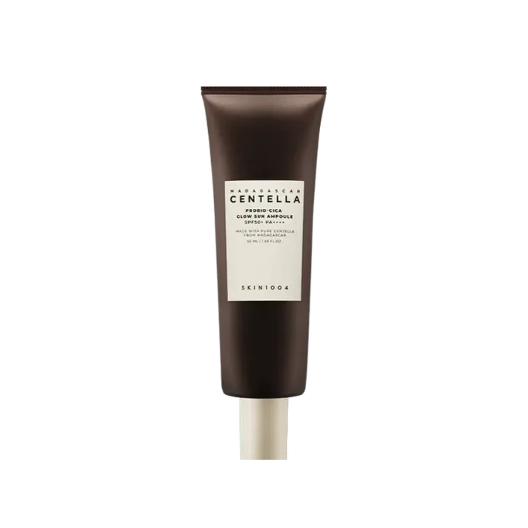 SKIN1004 Madagascar Centella Probio-Cica Glow Sun Ampoule SPF50+ PA++++ combines high sun protection with skin-nourishing benefits, delivering a radiant, healthy glow. Enriched with Centella Asiatica Extract and Lactobacillus Ferment, it soothes sensitive skin while promoting a strengthened barrier. Niacinamide brightens and evens skin tone, while Panthenol and Ceramide NP deeply hydrate and lock in moisture. The lightweight ampoule texture absorbs quickly without leaving a sticky or white cast, making it p